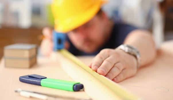 Arms of worker measuring wooden bar portrait. Manual job DIY inspiration improvement job fix shop yellow helmet joinery startup workplace idea hard hat career ruler industrial education