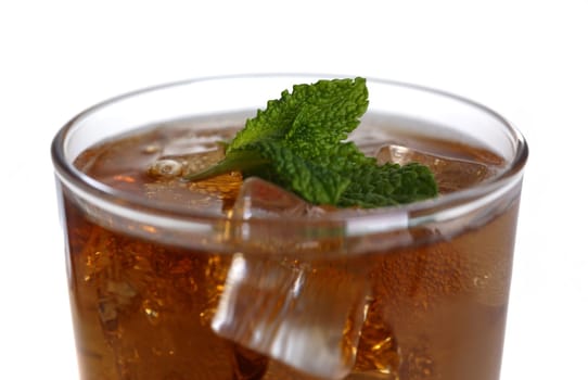 Cocktail whiskey cola with ice and mint in a glass isolated on white background