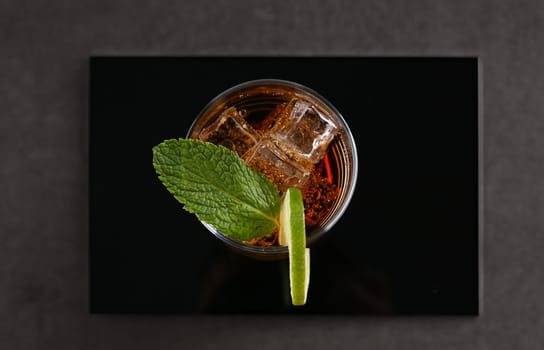 cocktail with cola and mint on a black background