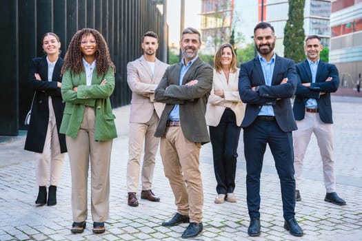 Business professionals confidently standing outdoors with their arms crossed. The image conveys professionalism, teamwork, confidence, and modern business attitudes, perfect for corporate themes.