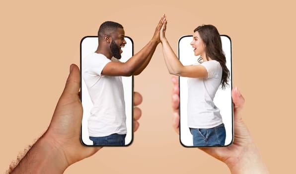 A couple engages with each other using smartphones, their hands touching through screens, showcasing modern communication in their relationship.