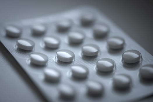 Closeup of pills in blister pack. Headache pills, painkillers, antibiotics or antidepressants tablets. High quality photo
