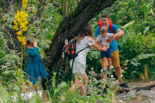 A family joyfully navigates through a lush green forest, sharing wonderful moments together in nature