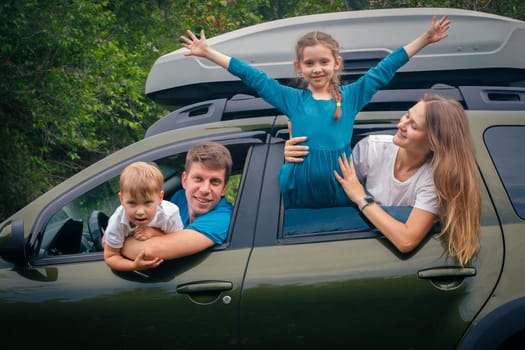 A joyful and cheerful family of four enjoying a funfilled outdoor trip together in their spacious SUV