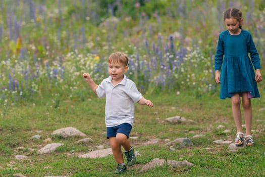 Two children are joyfully playing together amidst a field of vibrant wildflowers, delighting in natures beauty