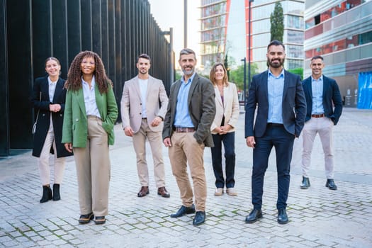 A diverse group of business professionals confidently standing outdoors . The image conveys professionalism, teamwork, confidence, and modern business attitudes, perfect for corporate themes.