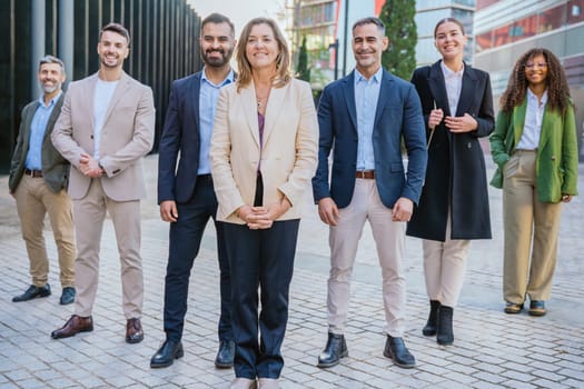 A diverse group of business professionals confidently standing outdoors . The image conveys professionalism, teamwork, confidence, and modern business attitudes, perfect for corporate themes.