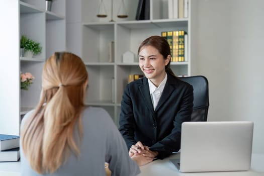 A cheerful lawyer engages with a client, discussing contract options and legal advice in a sleek office, highlighting professionalism and trust in legal services.