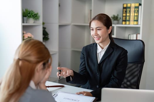 A friendly lawyer confidently explains key contract terms to a client, fostering a clear understanding of legal obligations in a modern office setting.
