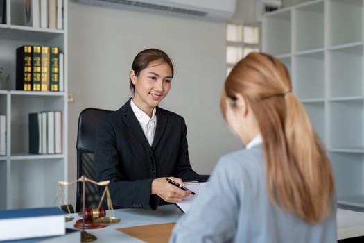 A professional lawyer attentively engaging with a client, reviewing important contract elements in a well-organized office setting designed for legal consultations.