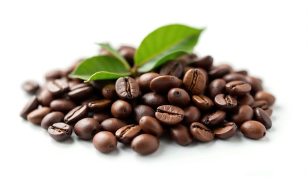 A pile of freshly roasted coffee beans is arranged artfully with vibrant green leaves on top, showcasing their rich color and texture in a bright setting.