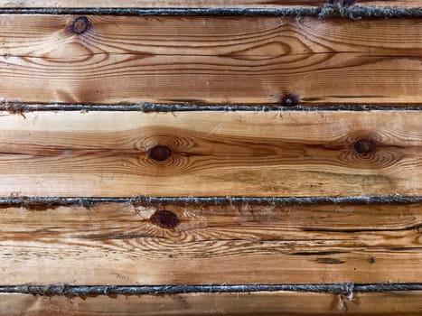 Natural wooden background features a textured pattern with smooth grain and subtle imperfections, providing a visually appealing space for text.