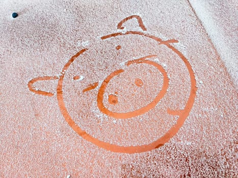 Snow on a playground features a playful pig design, showcasing creativity in a winter setting, perfect for children's imagination.