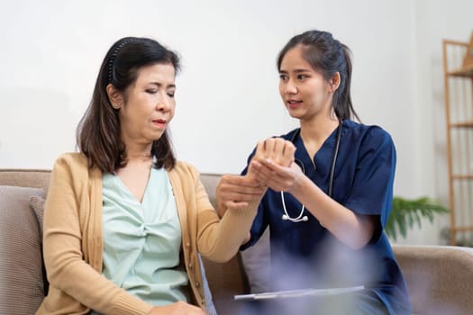 A focused caregiver taking the elderly patient pulse, demonstrating care and professionalism while ensuring the patient feels comfortable in a cozy environment.