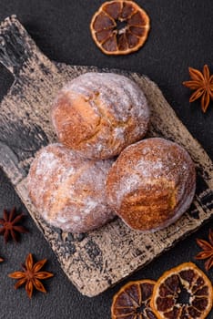Delicious round freshly baked cinnamon flavored cookies on dark concrete background