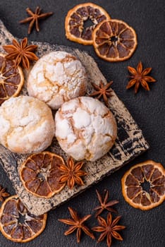 Delicious round freshly baked lemon flavored cookies on dark concrete background