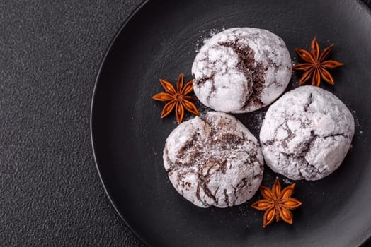 Delicious round freshly baked chocolate flavored cookies on dark concrete background
