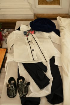 The christening suit for the boy is prepared in the church