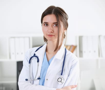 Beautiful smiling female doctor stand in office portrait. Physical and patient disease prevention exam er ward round 911 prescribe remedy healthy lifestyle consultant nurse profession concept