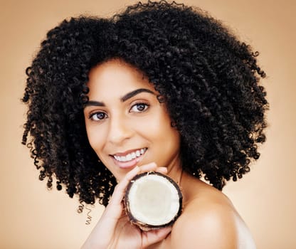 Woman, portrait and hair, coconut with shine and beauty, organic salon treatment for strong texture on studio background. Face, skin and natural cosmetic product for growth with haircare and fruit.
