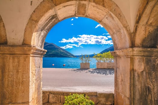 Kotor bay landscape through historic architecture arch, archipelago of Montenegro