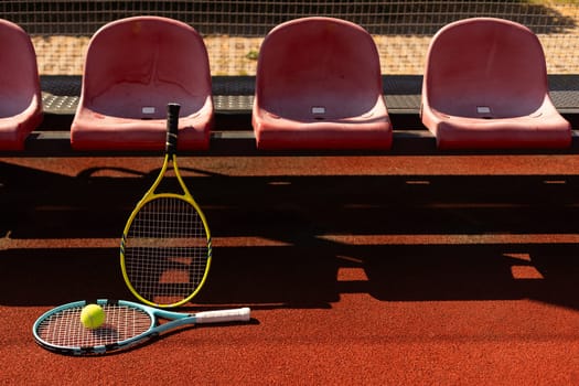 Close up view of tennis racket and balls on the clay tennis court. High quality photo