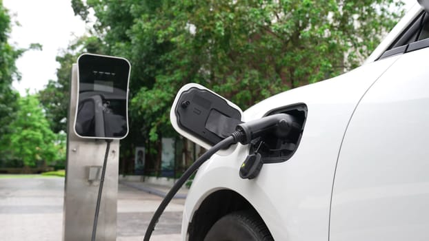 Progressive sustainability of energy concept by electric car parking and recharging next to home charging station. Electric vehicle driven by renewable energy for environmental preservation.