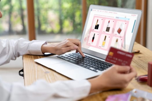 Woman shopping online on internet marketplace browsing for sale items for modern lifestyle and use credit card for online payment from wallet protected by uttermost cyber security software