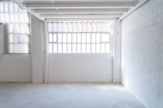 Empty industrial space with white walls and a door background with copy space for text. High quality photo