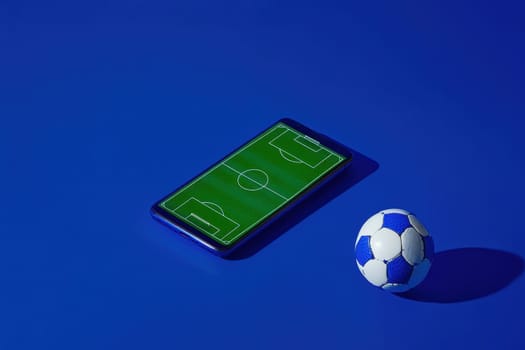 A vibrant smartphone showcases a soccer field design against a bold blue background, accompanied by a soccer ball, symbolizing sports enthusiasm and modern technology.