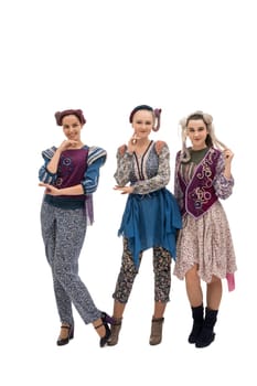 Young attractive women in colorful styled vintage clothes smiling and looking at camera