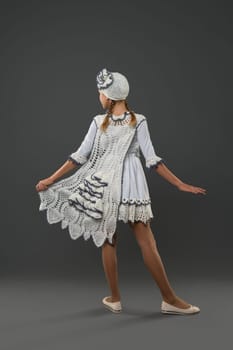 Pretty girl wearing fashion white dress and hat rearview view