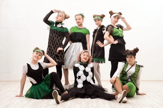 Girls wearing fashion green and black costumes isolated group view