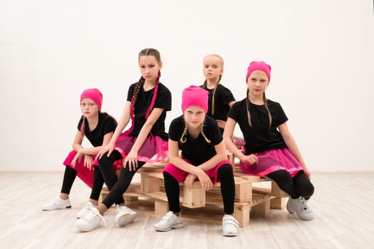 Young girls in pink bandanas and black t-shirts group shot