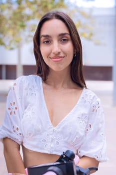 Portrait of woman with a smiling, Focus on her facial features and natural beauty, captured outdoors with soft lighting and an urban background.