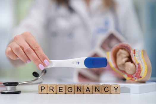 A pregnancy test that comes along with various medical tools illustrating important pregnancyrelated information