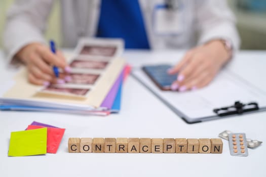 A healthcare professional discusses contraception options, using educational materials to improve understanding