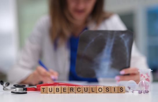 A skilled healthcare professional meticulously analyzes an Xray image for the detection of tuberculosis assessment