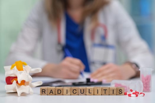 A doctor thoroughly studying radiculitis while examining a spinal model and reviewing notes in a clinical environment