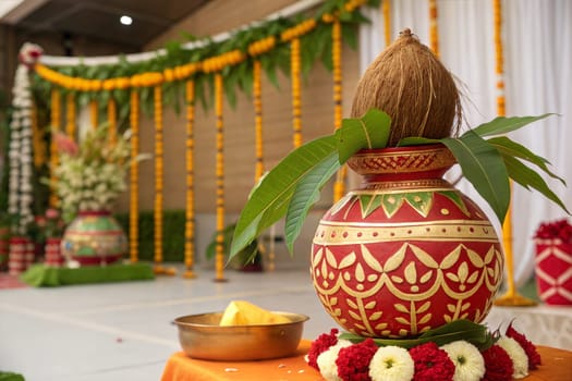 Copper and gold kalash with coconut and mango leaf with marigold flower decoration at the bottom for hindu puja for all hindu pooja occasions.