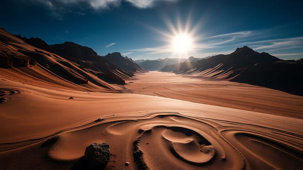 This stunning photograph captures the breathtaking beauty of a desert landscape at sunrise. The image showcases a vast expanse of red sand dunes sculpted by the wind, leading the eye towards a dramatic mountain range bathed in the golden light of the rising sun. The sun's rays create a starburst effect, adding a dramatic and ethereal quality to the scene. The intricate patterns etched into the sand by the wind further enhance the visual interest, offering a textural contrast to the rugged mountains. This image is perfect for use in travel brochures, calendars, websites, or any project requiring an evocative image of nature's power and beauty. The warm color palette and dynamic composition make it visually striking and instantly captivating.