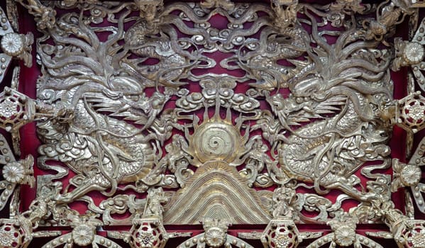 Samut Prakan, Thailand - Jan 11, 2025 - Elaborate sculptures on ceiling design inside the Buddhist temple of Wat Dhammakatanyu (Xian Lo Dai Tien Gong). Taiwanese art style, Look up, use it as your Wallpaper, Poster and Space for text, Selective focus.