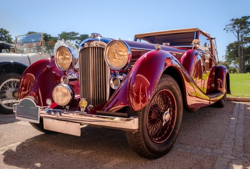 Lisbon, Portugal - Sep 29, 2024: Vintage red Lagonda LG45 on sunny day. Luxury sports car of 1930s, 2-door drophead coupe version, Lagonda, UK