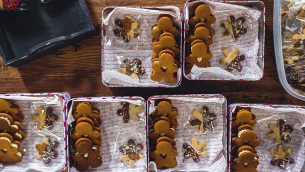 Flat lay. Lovingly homemade gingerbread and sugar cookies, half-dipped in rich chocolate, nestled in decorative Christmas tin boxes perfect for seasonal gifting.