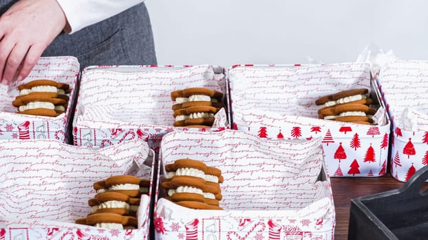 Lovingly homemade gingerbread and sugar cookies, half-dipped in rich chocolate, nestled in decorative Christmas tin boxes perfect for seasonal gifting.