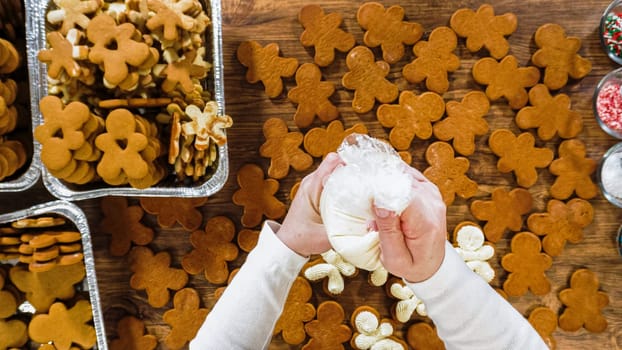 Flat lay. Crafting gingerbread cookie sandwiches with eggnog buttercream, presented on a rustic wooden table for Christmas gifting.