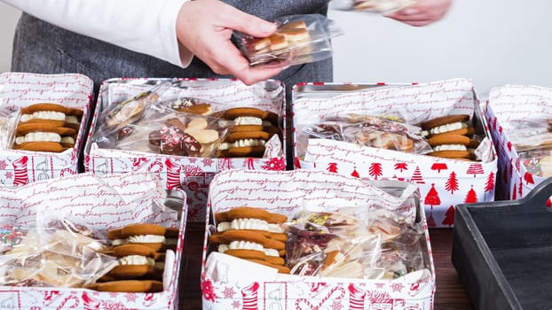 Lovingly homemade gingerbread and sugar cookies, half-dipped in rich chocolate, nestled in decorative Christmas tin boxes perfect for seasonal gifting.