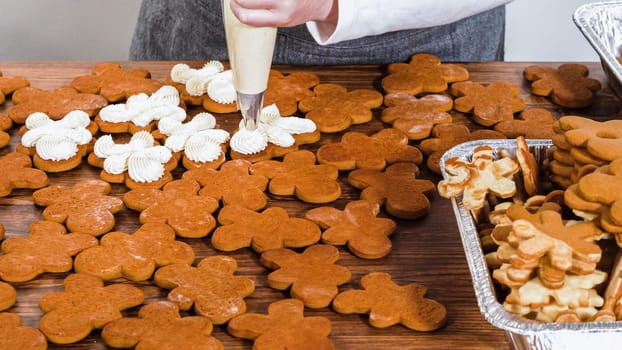 Crafting gingerbread cookie sandwiches with eggnog buttercream, presented on a rustic wooden table for Christmas gifting.