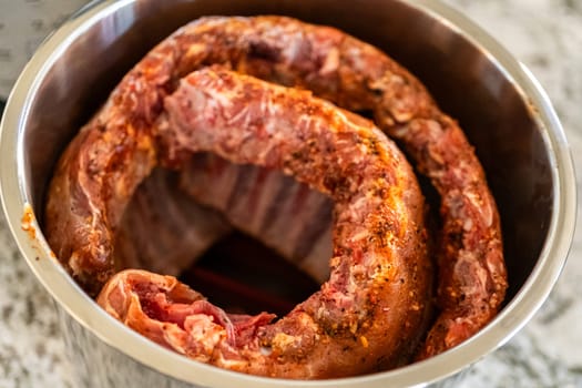 In a sleek modern kitchen, we adding an extra layer of flavor to succulent baby back ribs by infusing them with a medley of spices in a multicooker-a mouthwatering feast in the making.