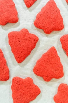 Close-up of baked Red Gingerbread Cookies in holiday shapes, displayed on a baking tray.